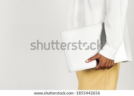 Black woman holding a laptop