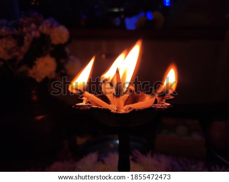 utttarakhand,india-3 may 2020:oil lamp in temple.this is a picture of traditional oil lamp in temple.flames in dark.diwali celebration.