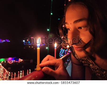 uttarakhand,india-3 may 2020:girl on diwali festival.this is picture of a girl lighting candles on the festival of diwali in india.this picture was taken with mobile at night.