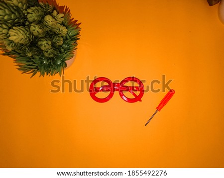 red glasses on the orange background