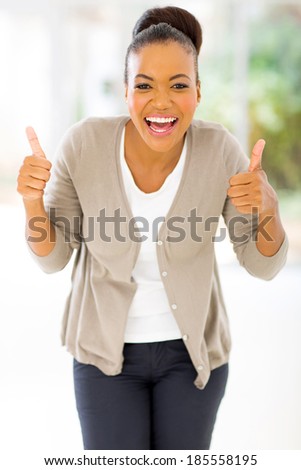 cheerful african woman giving two thumbs up as sign of approval