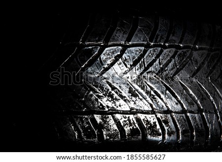 A tire made of metal on black background
