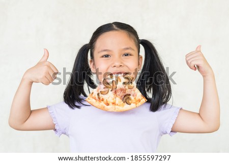mmm, so delicious!, i recommend eat this delicious pizza! surprised little asia girl keeps slice of pizza in mouth, points with thumb, wants to eat, positive woman with junk food, people and eating.