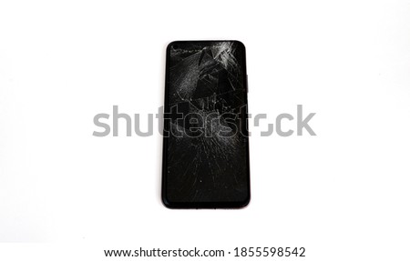 Modern black smartphone touch screen with broken screen, broken glass isolated on white background. The view from the top. copy space