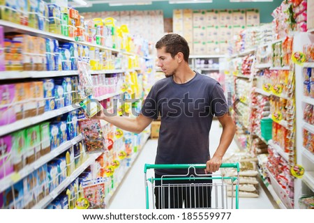 young man in supermarket Royalty-Free Stock Photo #185559977
