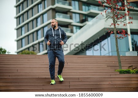 Young man jogging on stairs