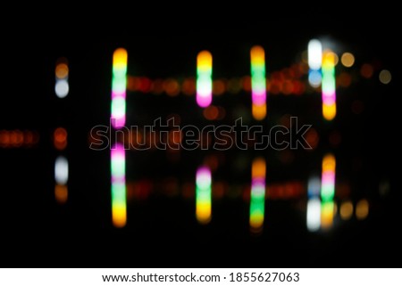 Blurred colorful bokeh lights in the night. Backgrounds for graphic design, Christmas holidays, New Year's festivals or celebrations.