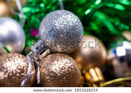 Shiny balloons and colorful tinsel elements of Christmas tree decoration, Close-up, selective focus. New year and Christmas.