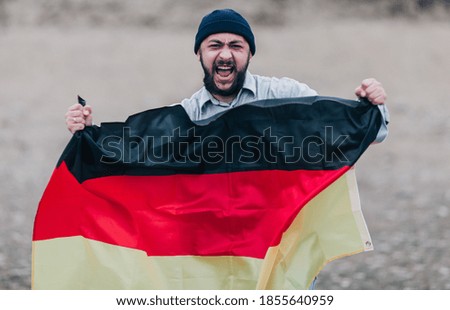 Man holding the Germany flag and celebrating