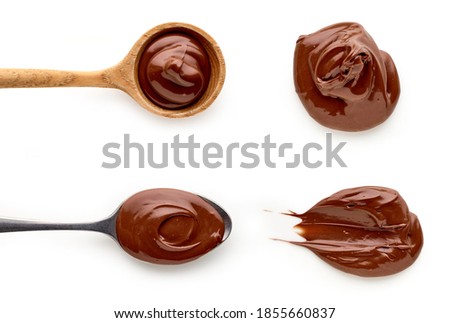 Chocolate nougat cream in spoons isolated on white background, top view Royalty-Free Stock Photo #1855660837