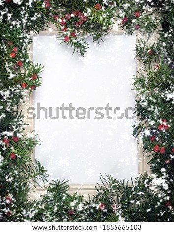 Christmas tree branches with red berries and frame paper card note and flying snowflakes. Copy space for text. Nature New Year concept. Flat lay.