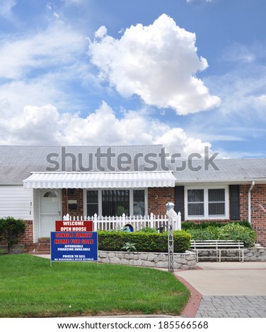 Real Estate For Sale Open House Welcome sign Suburban Brick Ranch style home landscaped front yard lawn Residential Neighborhood USA Blue Sky Clouds