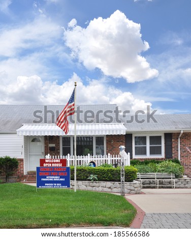 American Flag Pole Real Estate For Sale Open House Welcome sign Suburban Brick Home Residential neighborhood USA blue sky clouds