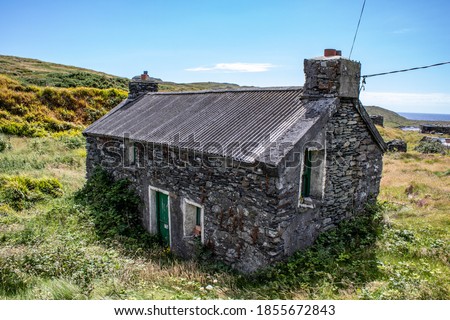 Abandoned and empty Irish Cottage in the countryside of West Cork  Royalty-Free Stock Photo #1855672843