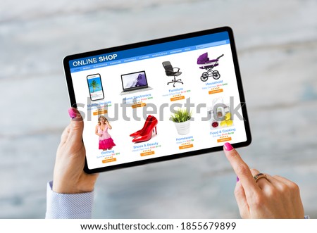 Woman shopping on online store by using tablet computer Royalty-Free Stock Photo #1855679899
