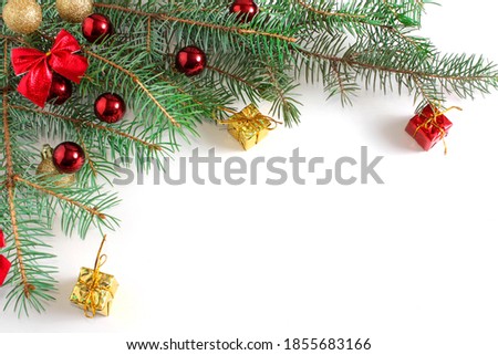 White Christmas background with Christmas tree branches and red balls, baws, giftboxes, winter festive composition with copy space. Close up.