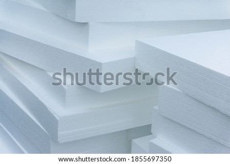 Expanded polystyrene plates. A stack of building materials for house insulation. Close-up Royalty-Free Stock Photo #1855697350