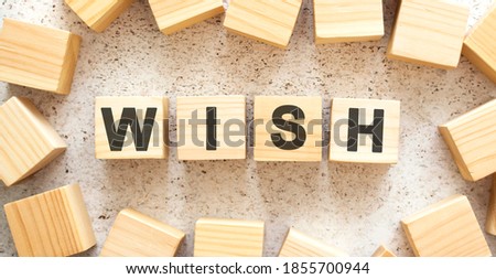 The word consists of wooden cubes with letters, top view on a light background. Work space.