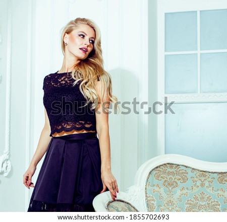 pretty blond woman in rich luxury house interior, fashion people