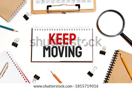 Business concept. Notebook with text Keep Moving sheet of white paper for notes, calculator, glasses, pencil, pen, in the white background