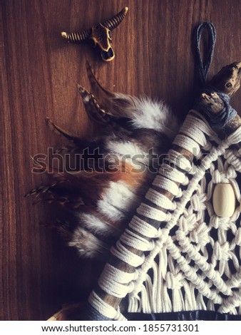 Handmade wall hanging white color with feathers. Home decor photo