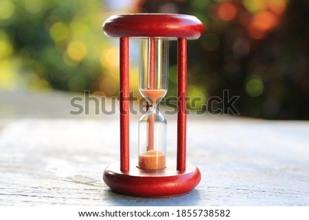 Close-up of the hourglass Light from a variety of natural colors to the background selective focus and shallow depth of field