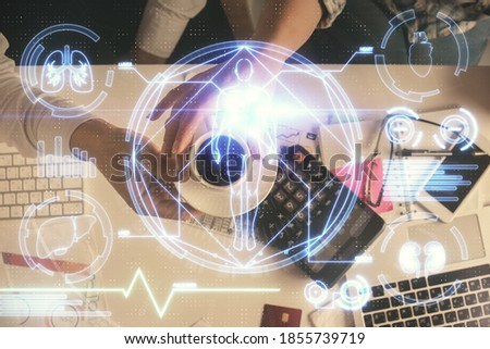 Double exposure of man and woman working together and education theme hologram drawing. Computer background. Top View.