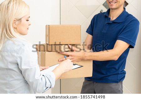 Woman sigining electronic receipt of delivered package