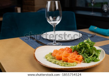 pieces of salmon and sauce in a white plate