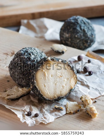 Swiss cheese Belper Knolle in the shape of small balls sprinkled with black pepper. Gourmet appetizer. Selective focus