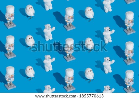 Creative Christmas pattern made with polar bears, owls and tin soldier on classic blue background. Minimal New Year concept. Top view, flat lay.