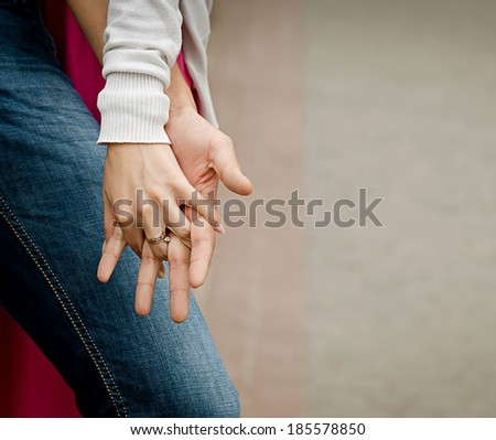 A young couple holding hands, outdoors 