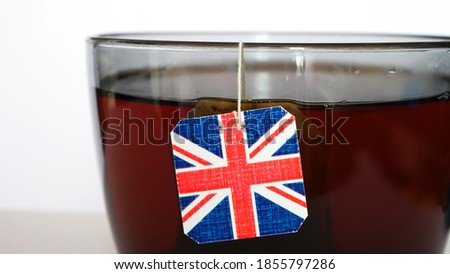 Close-up of a big cup of tea brewing using a tea bag with an english flag tag