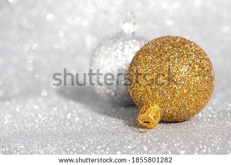 Christmas decorations made of gold and silver balls with blurred shiny background