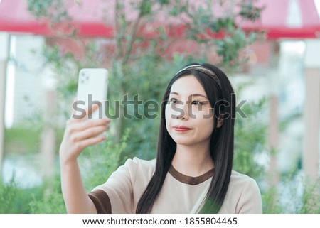 Young Asian woman operating a smartphone