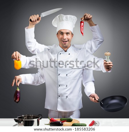 Humorous portrait of a chef with many hands on gray background Royalty-Free Stock Photo #185583206