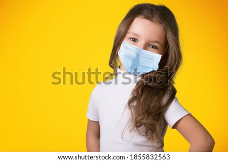 Portrait of attractive healthy pre-teen girl wearing safety face mask