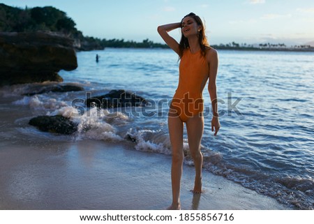 Woman in swimsuit near the beach island summer vacation