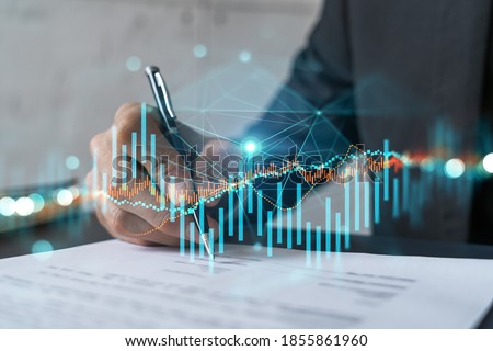 Businessman in suit signs contract. Double exposure with forex graph hologram. Man signing brokerage agreement. Financial market analysis and investment concept. Royalty-Free Stock Photo #1855861960