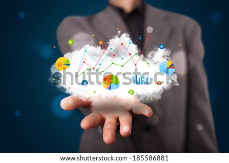 Young businessman presenting cloud with charts and graph icons and symbols