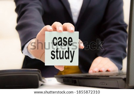 case study text written on a blue sticker held by a business girl. High quality photo
