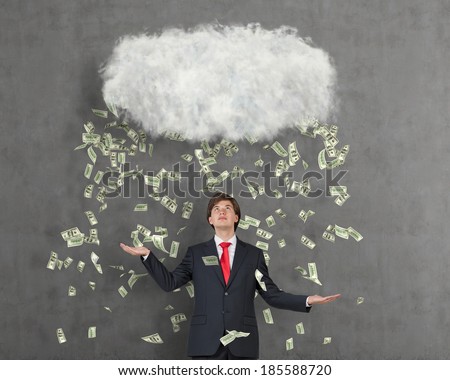 Cloud and money rain. Happy businessman,
