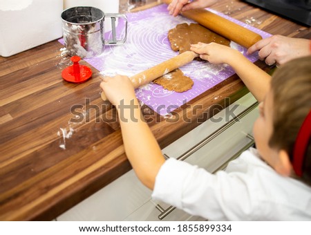 Mother and son having fun baking cookies