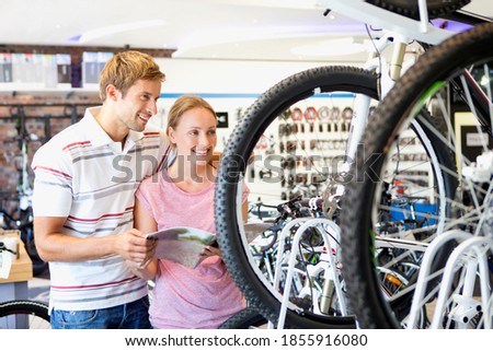 Couple choosing a bicycle in a shop