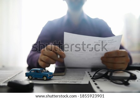 The insurance agent signs a document. Car insurance policy. Auto insurance policy. Forms registration of the contract.