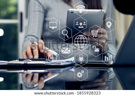 Businesswoman hand working with tablet and connection network icon, Digital marketing concept,  Blurred background.