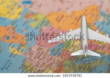 Toy of a plane flying over the Europe map.
