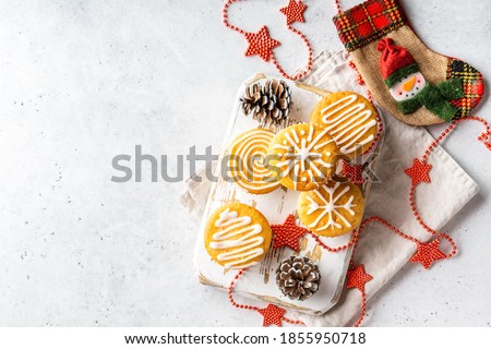 Christmas or New Year homemade sweet present mini cakes with icing sugar. White stone table background. Festive decoration. Flat lay, top view, copy space.