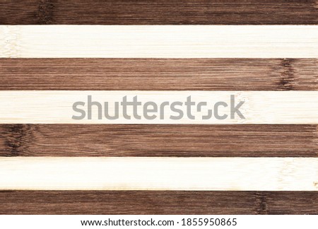 scratched old cutting board. Striped background.