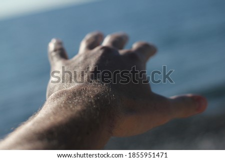 Holding hand at the beach of Black Sea in Sochi, Russia